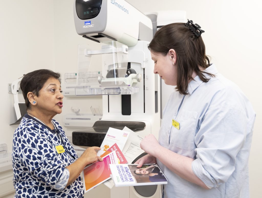 Two cancer clinical nurse specialists at the Royal Free Hospital discussing printed information for breast cancer patients